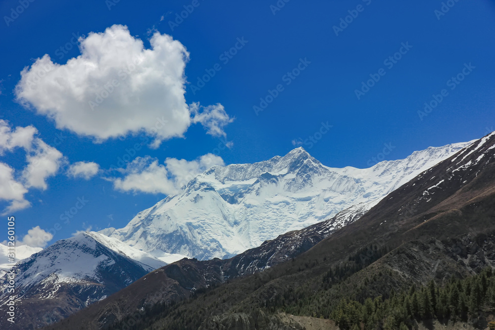 Snowy mountains of Nepal on a background of blue sky.