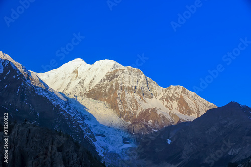 Snowy mountains of Nepal on a background of blue sky.