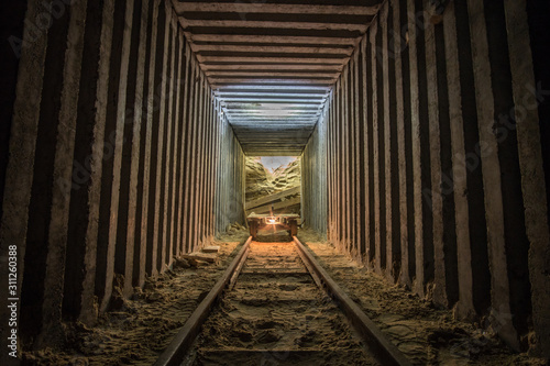 Fototapeta Naklejka Na Ścianę i Meble -  Empty mine cart (trollay) in tunnel.