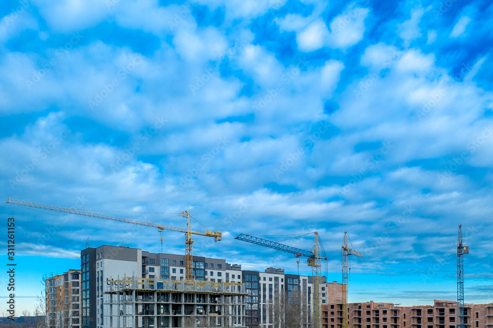 Construction site. High-rise multi-storey buildings under construction. Tower cranes near buildings Construction site. High-rise multi-storey buildings under construction. Tower cranes near buildings