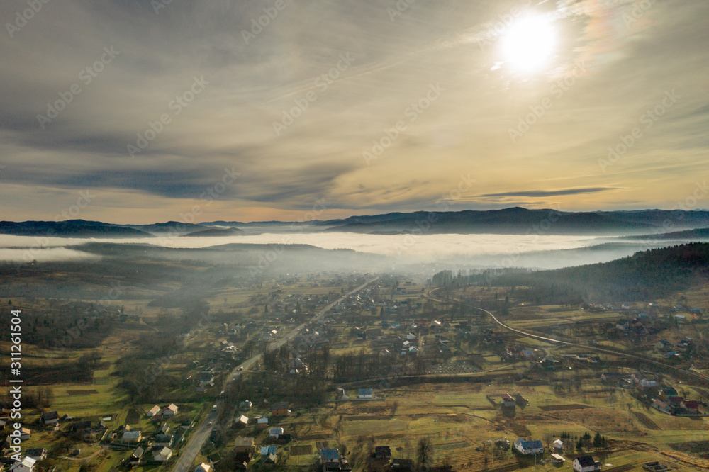 Image of beautiful village in the mountains, view of fog over little town, many houses in Lebanese mountain, gorgeous landscape, picturesque rural place, traveling and vacation concept