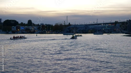 dragon boat team paddling at night photo