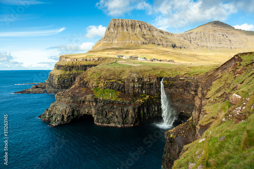 Picturesque waterfall in the village Gasadalur in the Faroe Islands photo