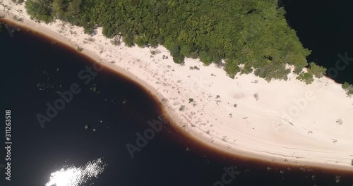 A white-sand beach on the Rio Negro, Anavilhanas National Park, in the Amazon rainforest. Tourist destination near the capital Manaus. Amazonas, Brazil. photo