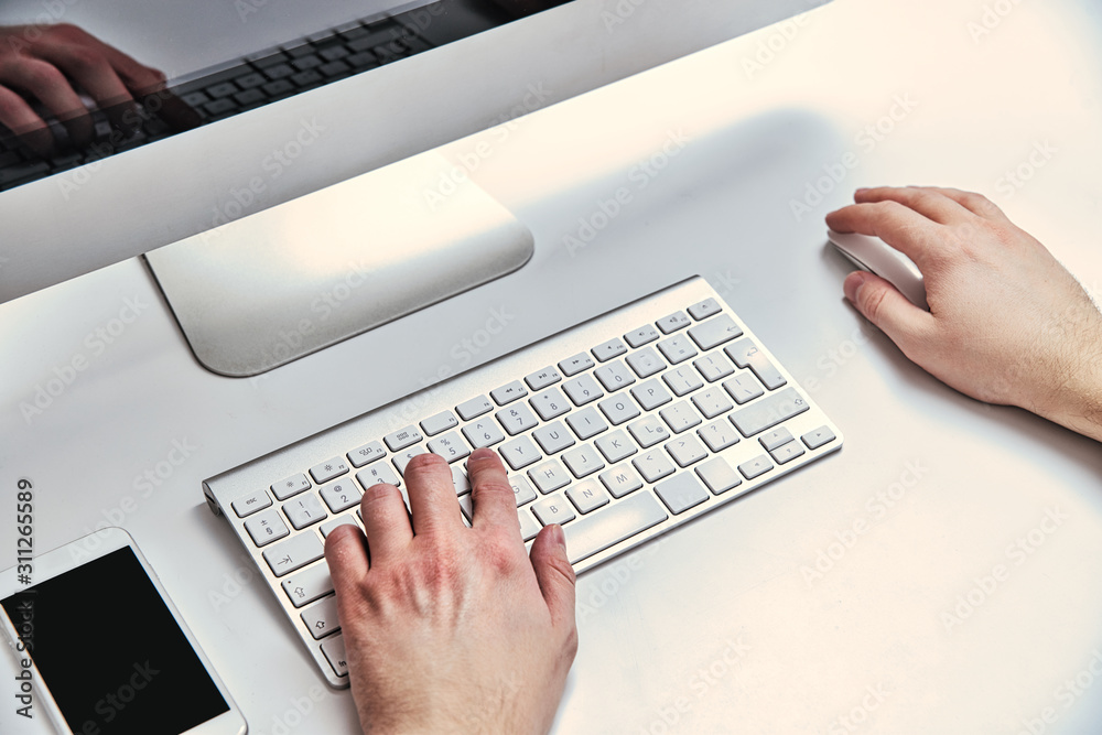 Computer work. A man typing on a computer keyboard. The concept of performing official duties. Typing on a computer, sending data. Computer work. A man typing on a computer keyboard. The concept of performing official duties. Typing on a computer, sending data.
