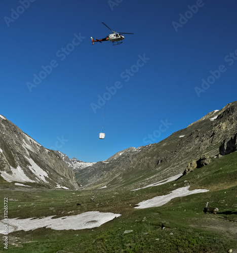 Helicopter Transporting Goods to Mountain Site in the Nepal