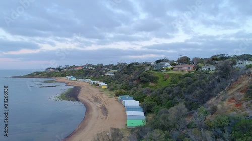 Aerial reveal of colorful bathing boxes on Ranelagh beach. Mount Eliza, Melbourne, Australia photo