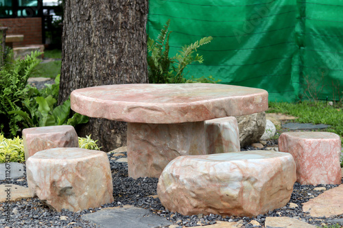Marble stone bench set in the garden. Stone furniture. © Janthana