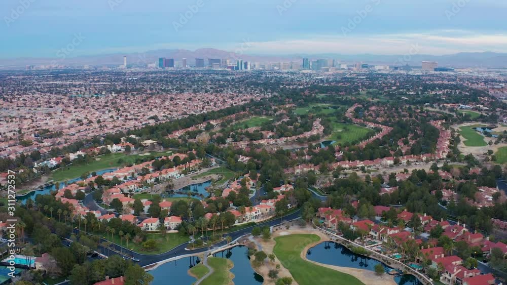 Aerial shot of Las Vegas suburban residence, houses, golf course, city skyline Aerial shot of Las Vegas suburban residence, houses, golf course, city skyline