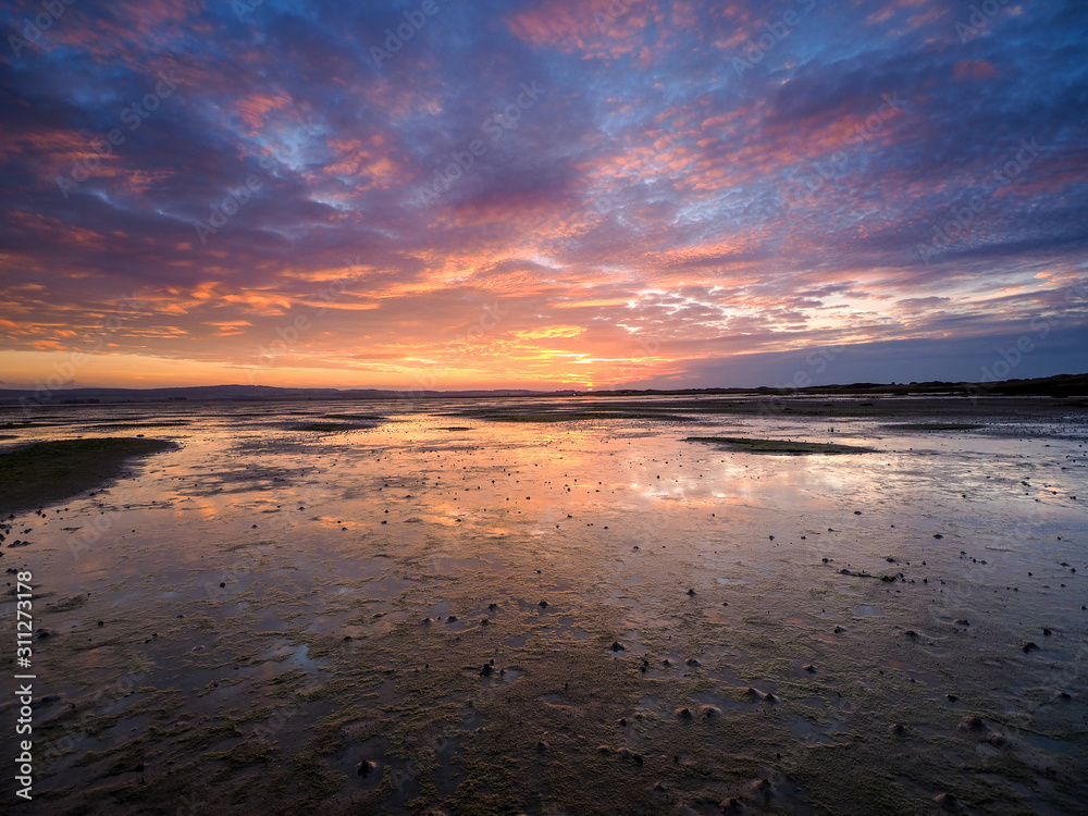 Sunset reflections at Holy Island at low tide Sunset reflections at Holy Island at low tide