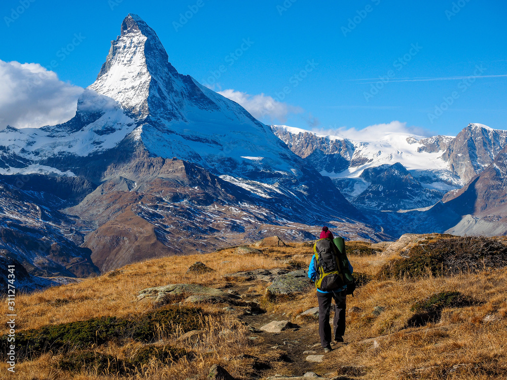 Matterhorn in early morning and trekker with outdoor equipment , Zermatt, Switzerland