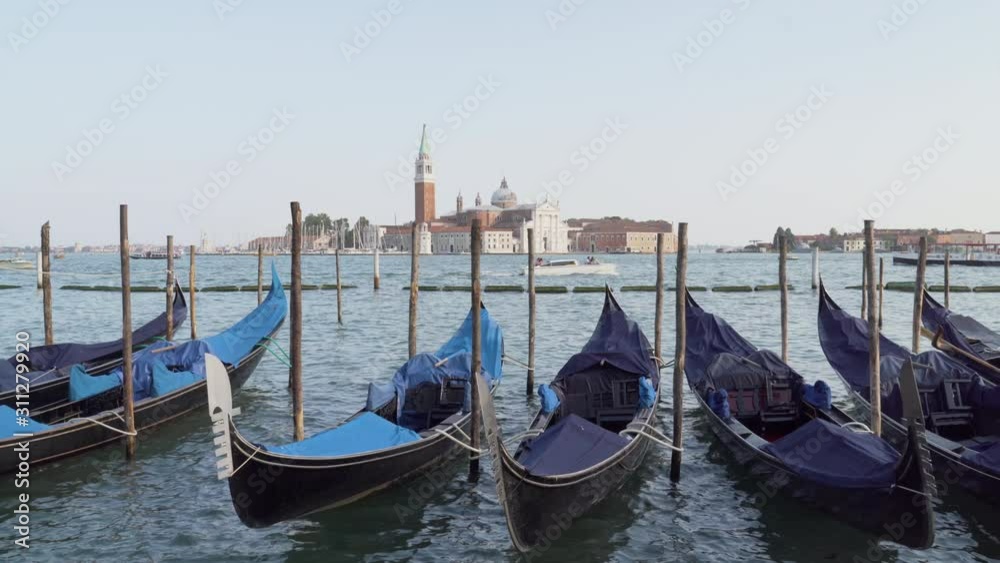 Gondolas moored in Venice, Italy, with a view to San Giorgio Maggiore Island Gondolas moored in Venice, Italy, with a view to San Giorgio Maggiore Island