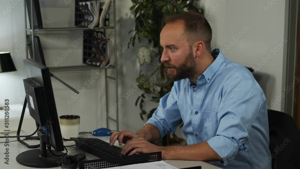 Male office worker, working late Male office worker, working late
