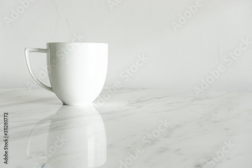 white coffee cup on marble table