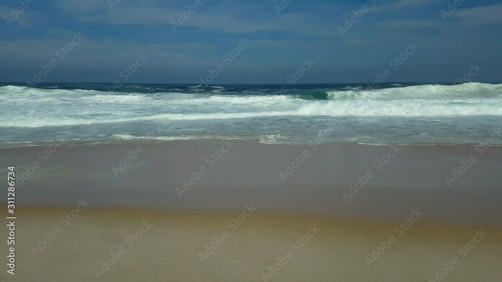 Waves breaking, white foam, blue sky and sea, in Itacoatiara beach, Brazil. Waves breaking, white foam, blue sky and sea, in Itacoatiara beach, Brazil.