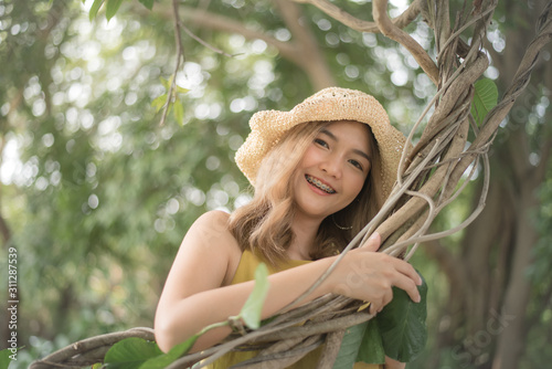 Portrait of young beautiful asian woman was holding the vines and smiling so sweet