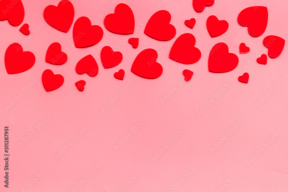 Valentine's Day design. Red hearts frame on pink background top-down copy space