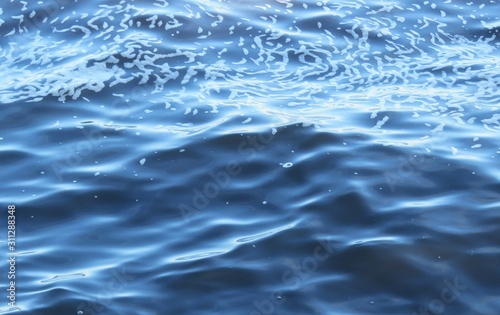 Foam and ripples on blue water background in Florida lake