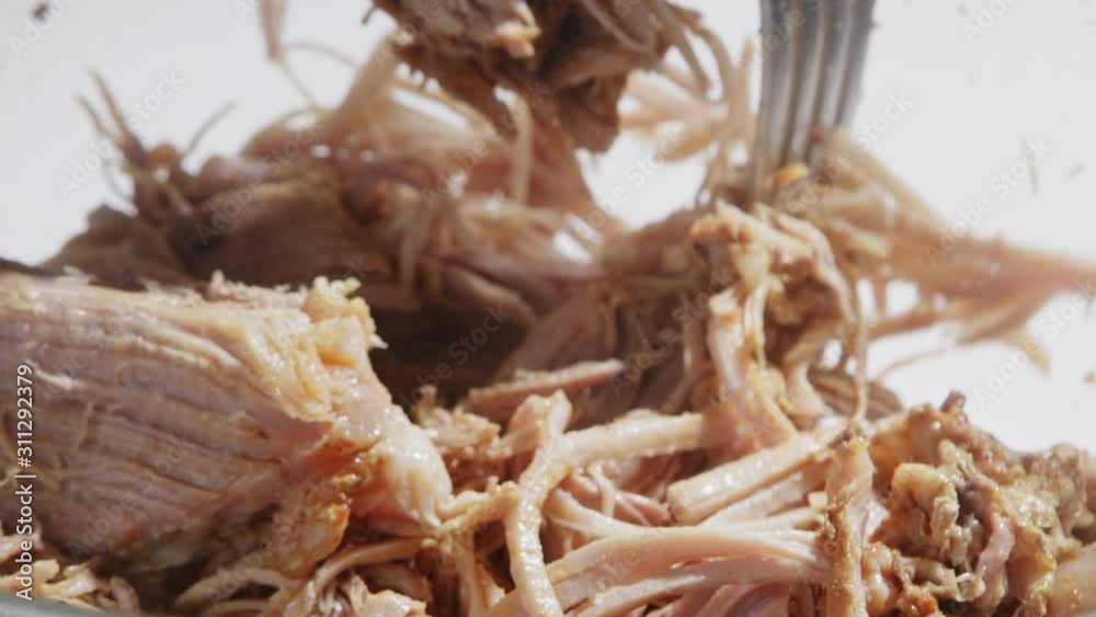 Shredding pulled pork with two forks Shredding pulled pork with two forks