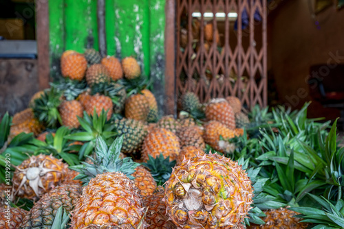 ripe and fragrant pineapples on a bright green background. concept of summer, relaxation and healthy food photo