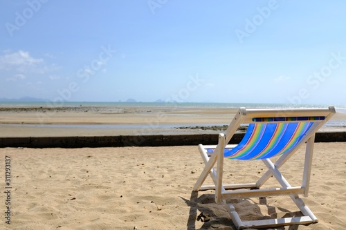 Fototapeta Naklejka Na Ścianę i Meble -  Lounge Chair on a Beach Overlooking the Ocean