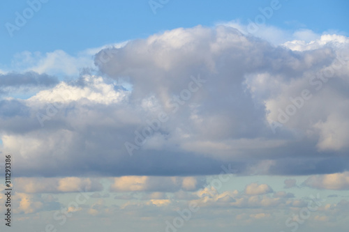 Fototapeta Naklejka Na Ścianę i Meble -  Cloudy sky with a parts of clear blue sky on a sunset. Natural background.