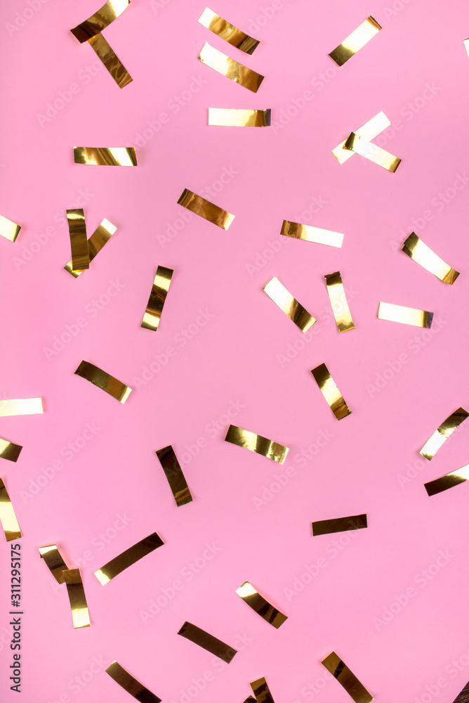 Gold confetti on pink background. Flat lay, top view. Gold confetti on pink background. Flat lay, top view.