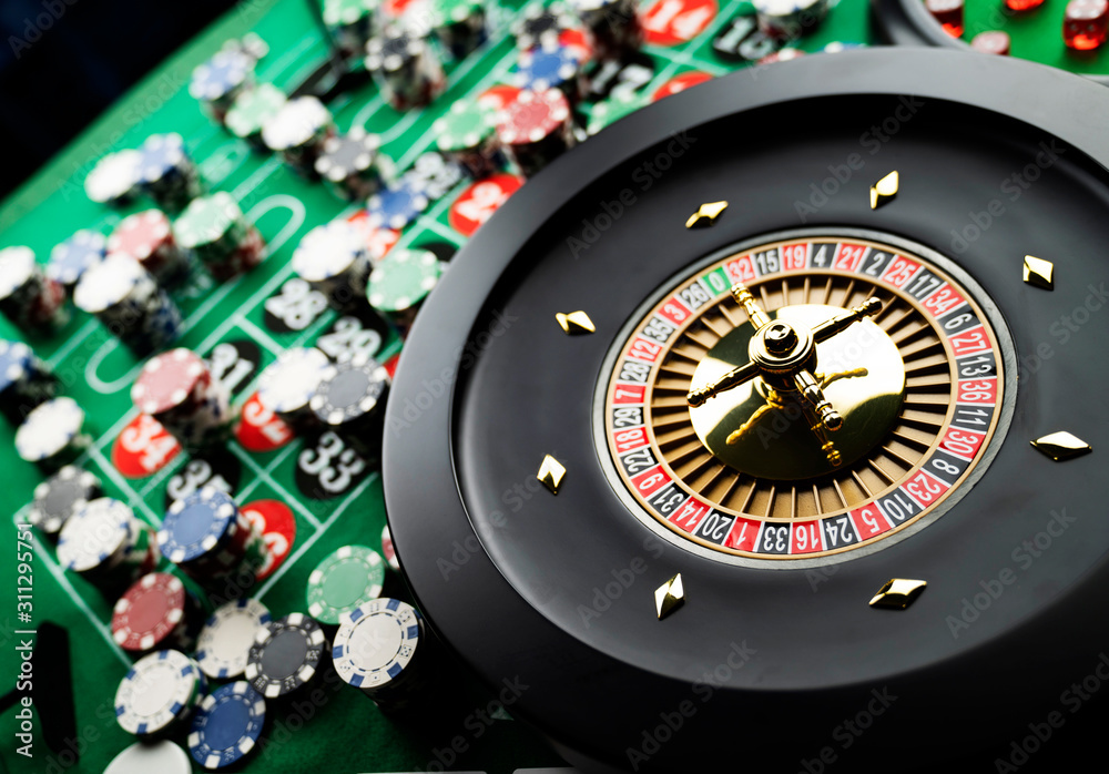 Casino theme, close up of roulette, red and black numbers, Stack of chips as background. Casino theme, close up of roulette, red and black numbers, Stack of chips as background.