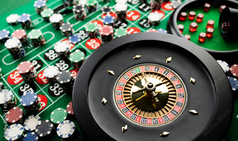 Casino theme, close up of roulette, red and black numbers, Stack of chips as background. Casino theme, close up of roulette, red and black numbers, Stack of chips as background.