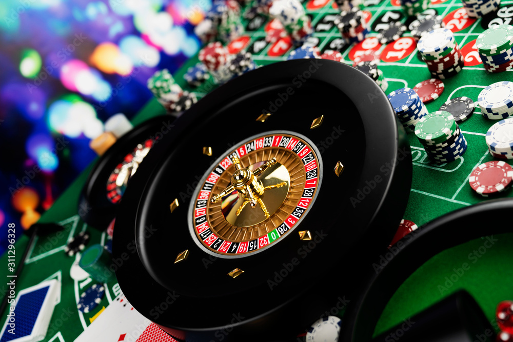 Casino theme, close up of roulette, red and black numbers, Stack of chips as background. Casino theme, close up of roulette, red and black numbers, Stack of chips as background.