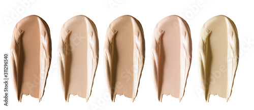 Foundation makeup swatch smear smudge set. Beige brown cosmetic cream concealer strokes isolated on white background. Color corrector of different shades collection photo