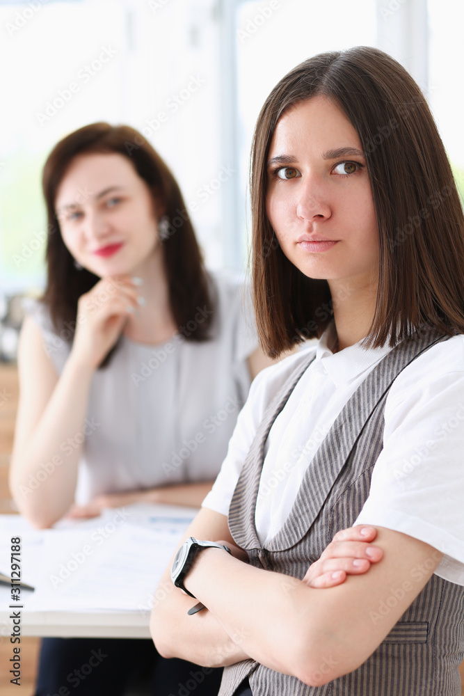 Beautiful girl at workplace with ars crossed Beautiful girl at workplace with ars crossed