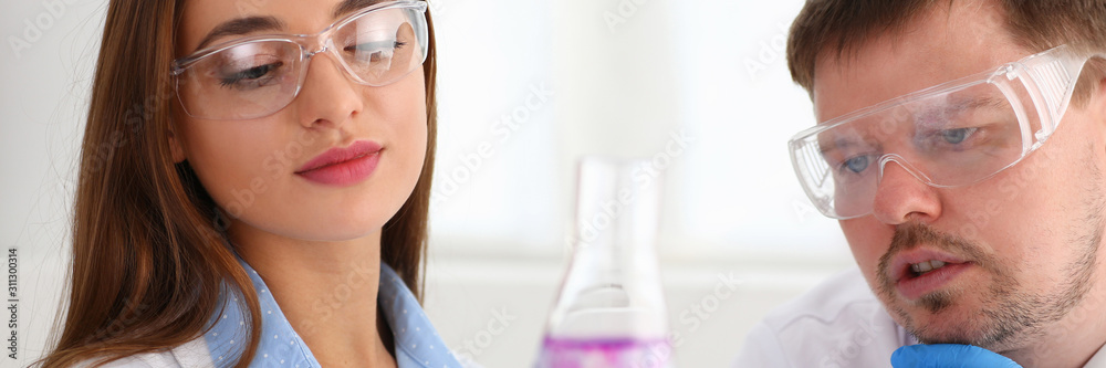 Technician hold in arms in protective gloves sample bottle Technician hold in arms in protective gloves sample bottle