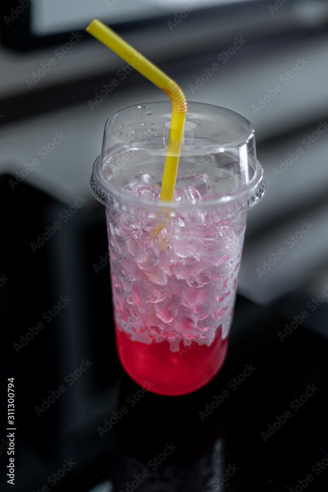 Glasses of sweet water red soda with ice cubes.