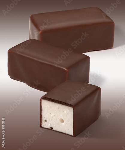 Candies whipped Cream in chocolate on a white brown background