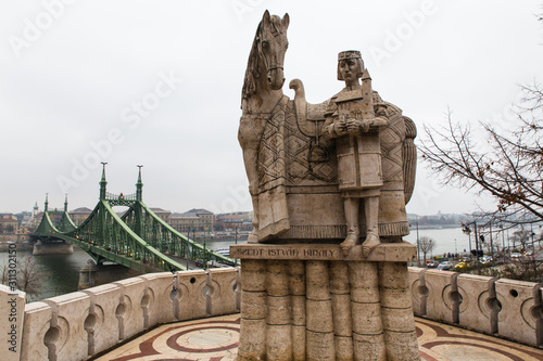 statue of king saint Stephen I overlooking the Danube River and Szabadsag Bridge, Budapest, Hungary © anyabr