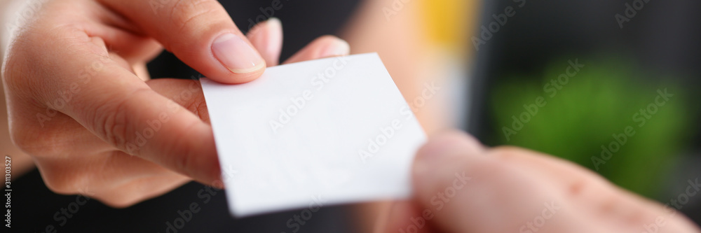businesswoman give her business card to her new partner closeup - obrazy, fototapety, plakaty 