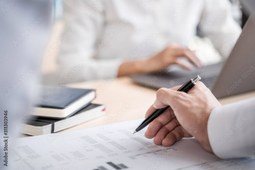 Team of Business people discussing a project of financial plan for marketing. Team of Business people discussing a project of financial plan for marketing.