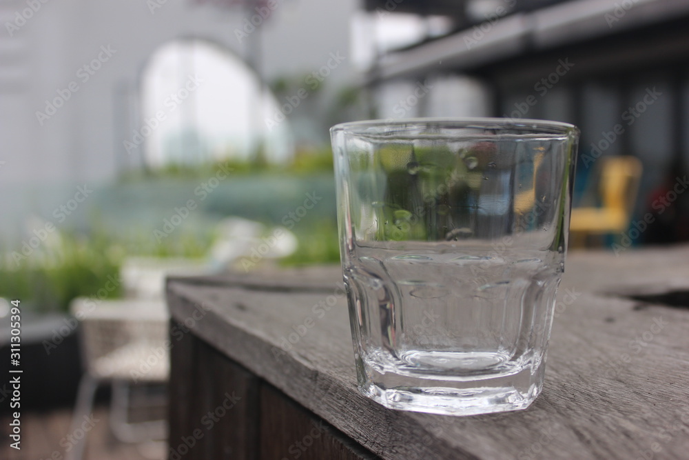 an empty glass on the table with blurred background an empty glass on the table with blurred background