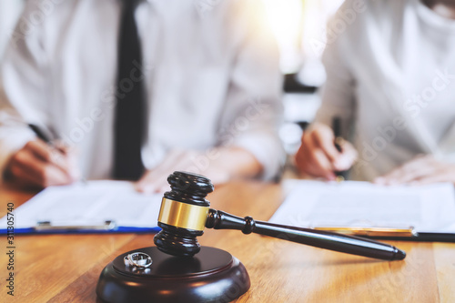 Judge gavel with pair of marriage ring, Divorce concept.