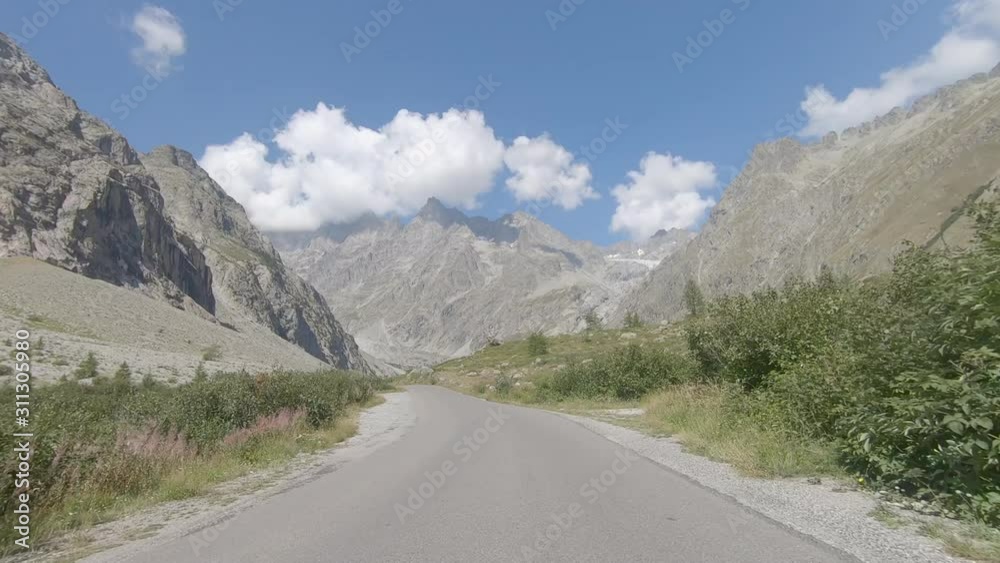 Vehicle point of view shot while driving on the road climbing to the base of the climbing route to the Glacier Blanc in Ecrins Massif in Hautes Alpes in France
