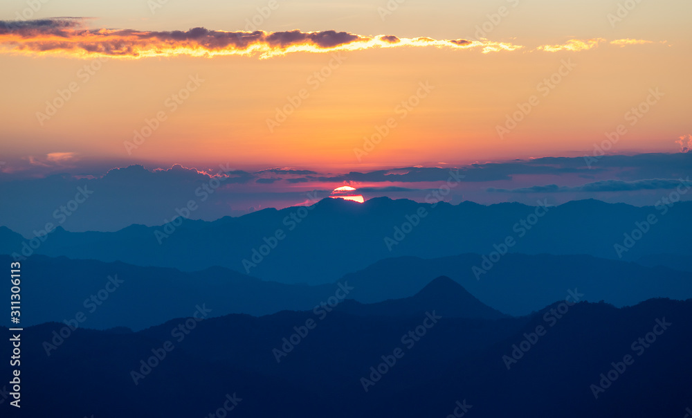 colorful dramatic sky with cloud at sunset  in the mountains