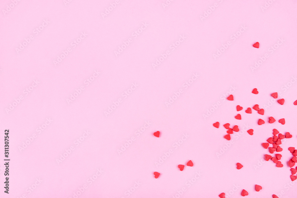 Pink background with red hearts. Valentine's day concept. Top view. Copy space for text.