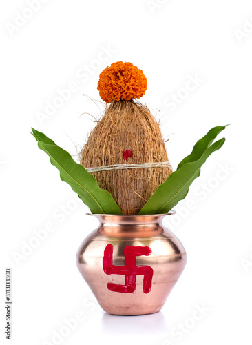 Copper Kalash with coconut and mango leaf with floral decoration on a white background. Essential in Hindu Puja.