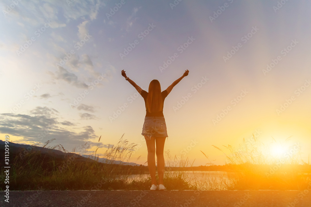 A young girl prayed for God's blessings with the power and holiness of God On the background blurring the sunlight up in the morning.The concept of God and spirituality.