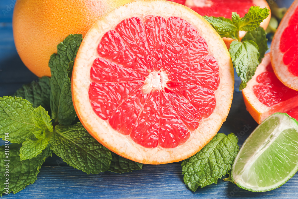 Fresh grapefruits and lime on table, closeup Fresh grapefruits and lime on table, closeup
