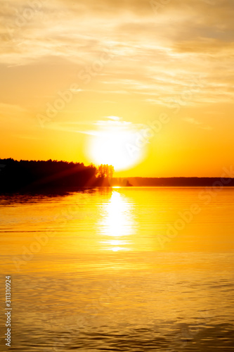 Blurred background. Beautiful golden sunset over a lake 