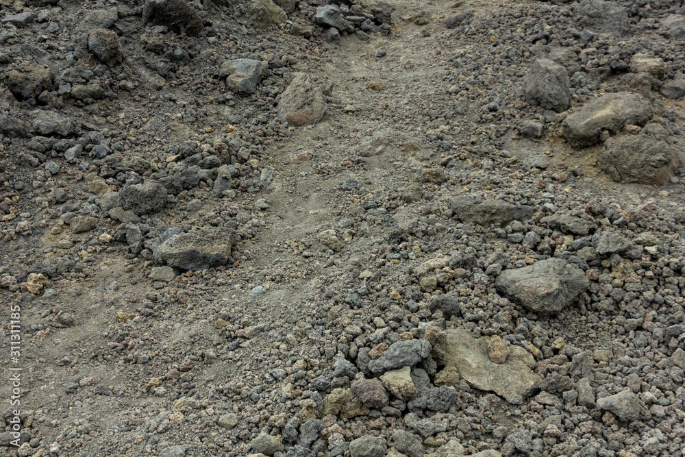 Path among the stones on the black ground of Lava of a Etna Volcano Path among the stones on the black ground of Lava of a Etna Volcano