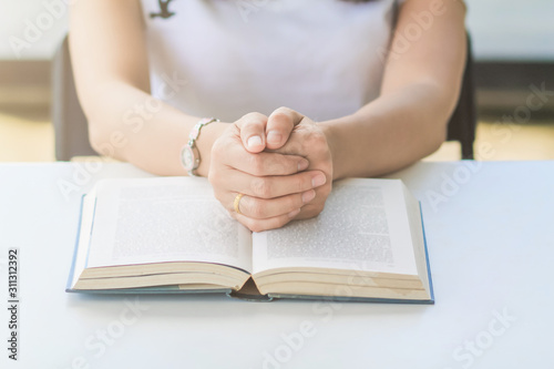 The Bible placed on the table was opened for learning to understand the Bible in order to pray to God and to ask God to protect himself and his family. The concept of Bible learning and faith in God