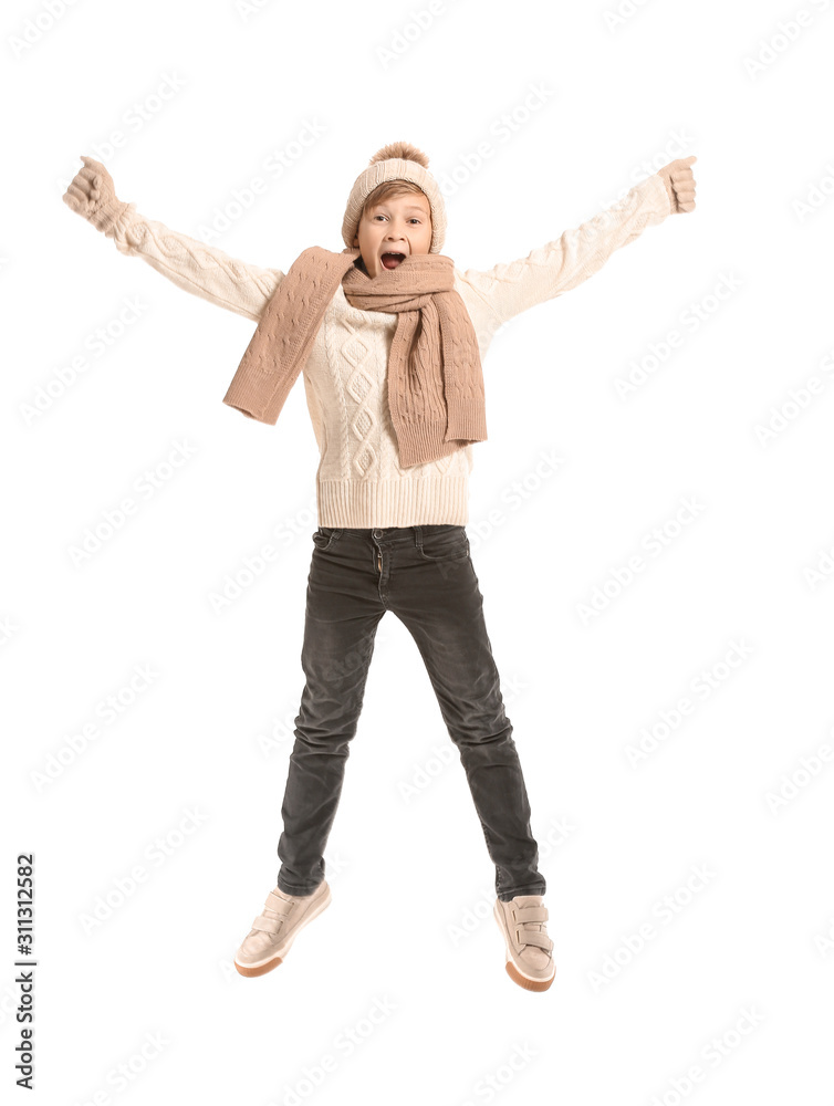 Jumping little boy in winter clothes on white background Jumping little boy in winter clothes on white background